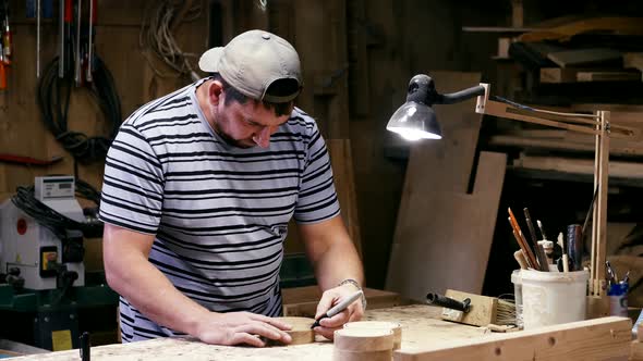 Male Carpenter Marking Figure Lines for Milling on a Wooden Detail