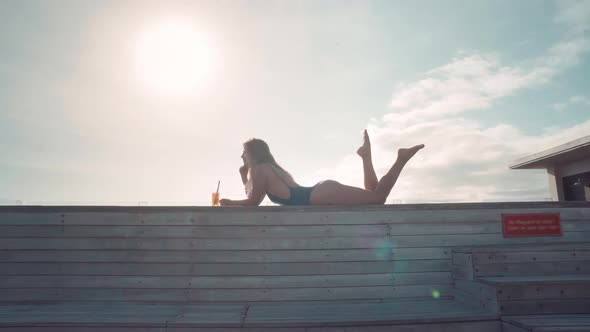 Beautiful Blonde Relaxing at Poolside