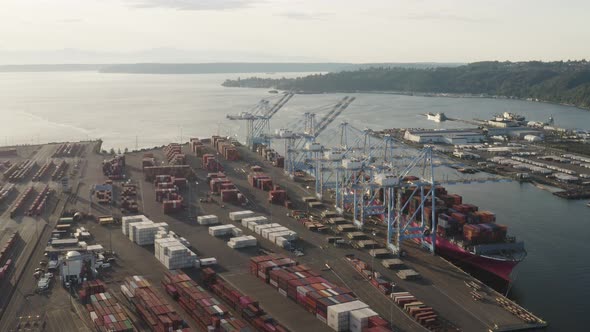 Freight Containers  And Quay Cranes In The Husky Terminal Within The Confines Of Tacoma Port Washing