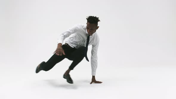 Office Worker in Work Clothes is Dancing Breakdance on White Background