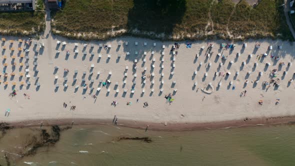 Aerial Birds Eye Overhead Top Down View of Tourist Beach in Scharbeutz Germany with Beach Chairs and