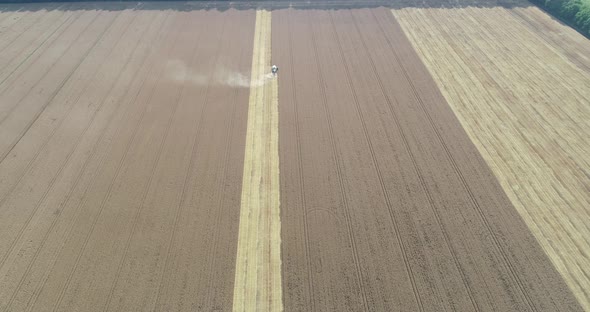 Combine harvester, harvest wheat on the field. Aerial drone view