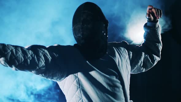 Male Fencer in a Protection Mask While Practicing in Slow Motion