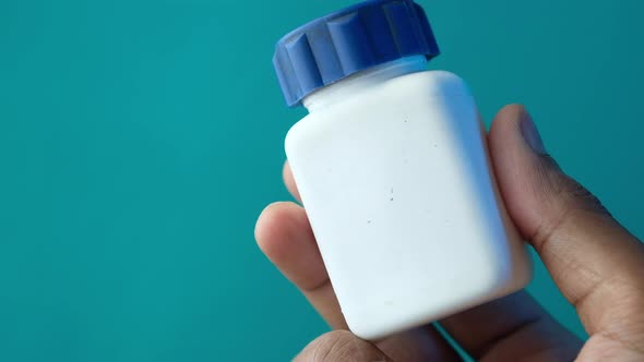 Close Up of Person Hand Holding Pill Container 