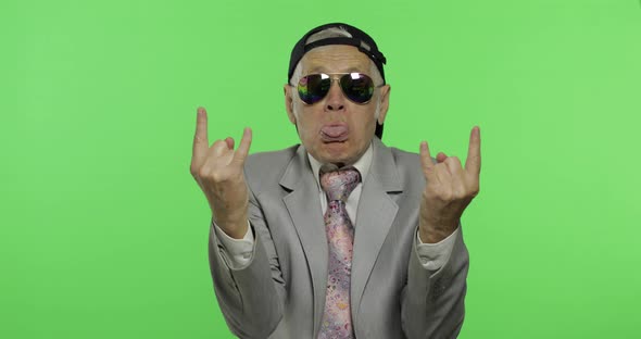 Funny Senior Businessman in Sunglasses Show Sign of the Horns with His Hands