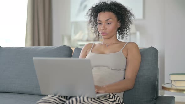 African Woman Working on Laptop at Home