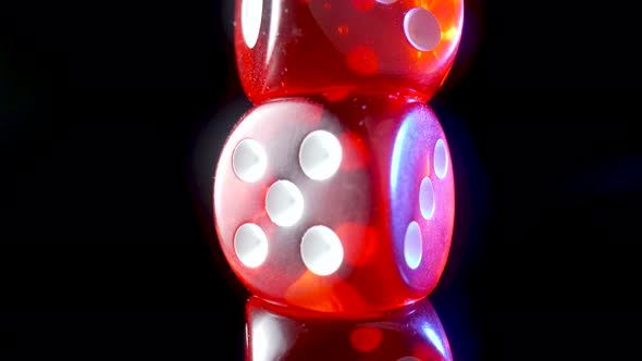 Red Dice Spinning on an Isolated Black Background