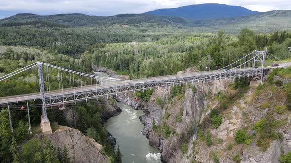 4k aerial footage of orbiting cameraement around Hagwilget canyon bridge crossing Skeena river in Br