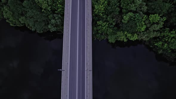 Top Aerial View to the Car on the Old Bridge Over the River