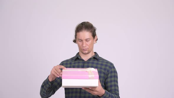 Happy Hipster Man Opening Gift Box and Looking Surprised