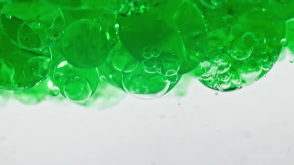 Macro Shot of Various Air Bubbles in Water Rising Up on Light White Background