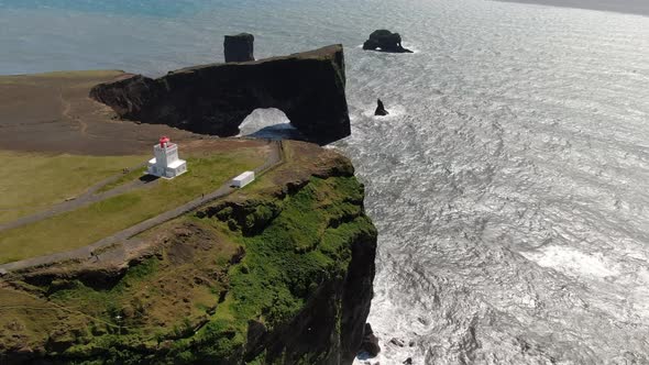 Aerial shot of Dyrholaey lighthouse and lava arch near Vik i Myrdal, Iceland