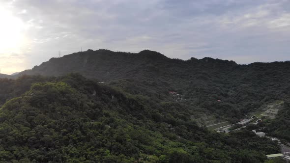 Right aerial pan of Taipei city green mountains