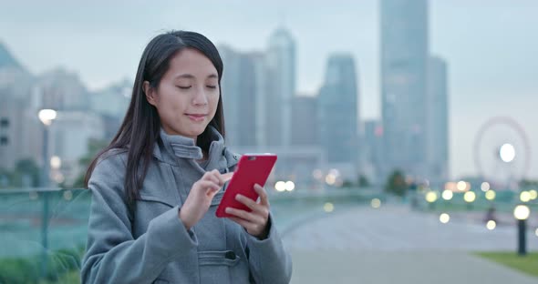 Woman look at mobile phone in city