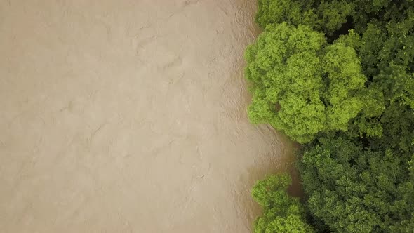 Aerial view of wide dirty river with muddy water in flooding period during heavy rains in spring