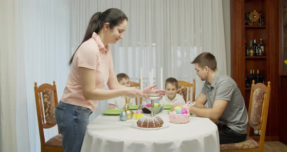 Happy Chef Mother Woman in Pink Shirt Sprinkling Powder on Top of Kitchen Table at Home Concept of