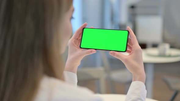 Woman Browsing Smartphone with Green Chroma Key Screen