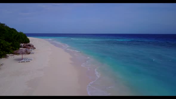 Aerial top down scenery of paradise tourist beach journey by blue green ocean with white sandy backg
