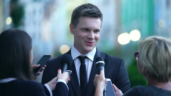 Smiling Male Millionaire Giving Interview on Press Conference, Public Relations