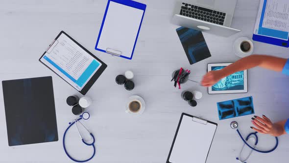 Nurse Analysing Human Brain Using Tablet on Flatlay