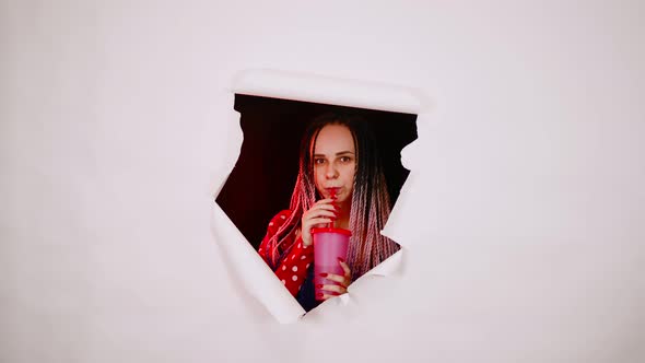 Barmaid with Drink Looking Through Hole in Paper Background