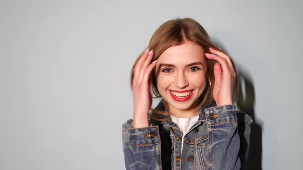 Young beautiful smiling blond woman looking at camera