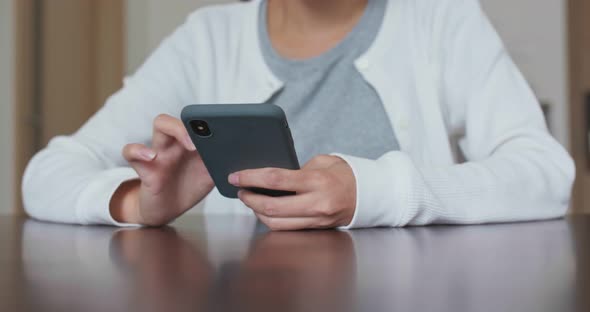 Woman use of mobile phone at home