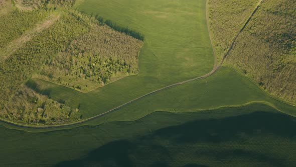 Aerial View of Green Summer Forest with Green Fields at Majestic Sunrise Meadows