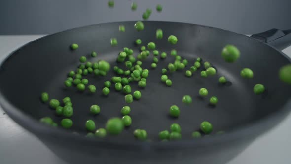 Green Peas Fall in Slow Motion To the Pan, Fresh Vegetables Are Falling 