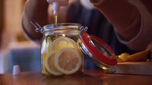 Woman making honey pickled lemon