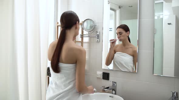 Dental Health. Woman Brushing Teeth In Bathroom