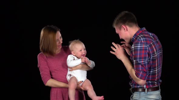 Family with Young Child Playing Together. Black