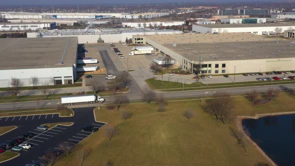 heavy goods transport by tractor trailers in Chicago logistics area, tracking shot