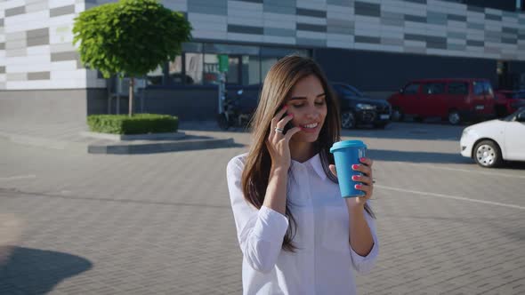 Portrait of Beautiful Stylish Woman Enjoying Talking on the Phone and Drinking Coffe to Go While