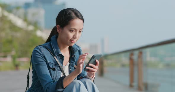 Woman Talk to Smart Phone in City