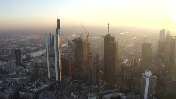 AERIAL: View of Frankfurt Am Main, Germany Skyline with Sunflair Between Skyscrapers in Beautiful