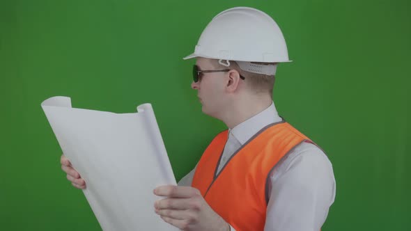 Builder Opens and Looks Technical Drawing About New Construction. Chromakey. Engineer and Real