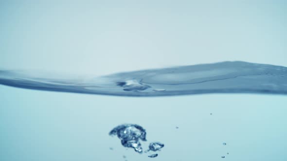 Water surface splashing and bubble rising. Slow Motion. alt