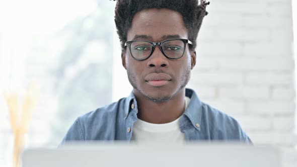 Portrait of Young African Man Showing Thumbs Up at Work