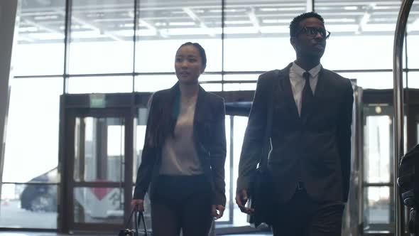 Business Representatives Walking Through Hotel Hall