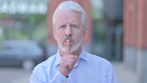 Outdoor Old Man Putting Finger on Lips