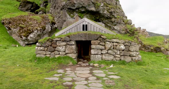 Ancient stone house in rural Iceland with gimbal video walking forward.