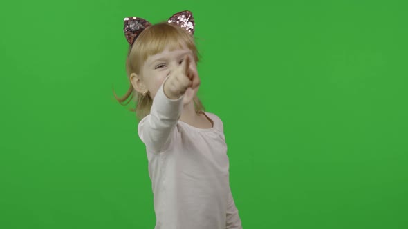 Girl in Headband with a Cat Ears Emotionally Points at Something with Her Hands