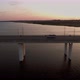 Aerial Shot of a Long Bridge with a Moving Bus in Ukraine at Sunset in Summer - VideoHive Item for Sale
