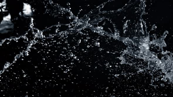 Super Slow Motion Shot of Side Water Splash Isolated on Black Background at 1000fps.