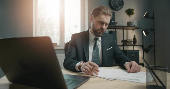 Businessman Working on Laptop in Office