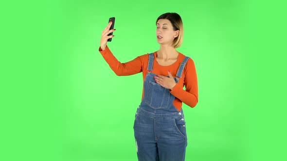 Girl Talking for Video Chat Using Mobile Phone. Green Screen