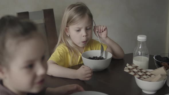 Baby in a Yellow Tshirt is Having Breakfast