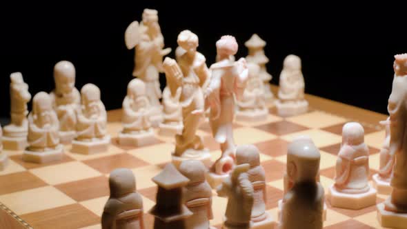 Camera orbiting Chessboard game, queens battle. Thematic Chess pieces.