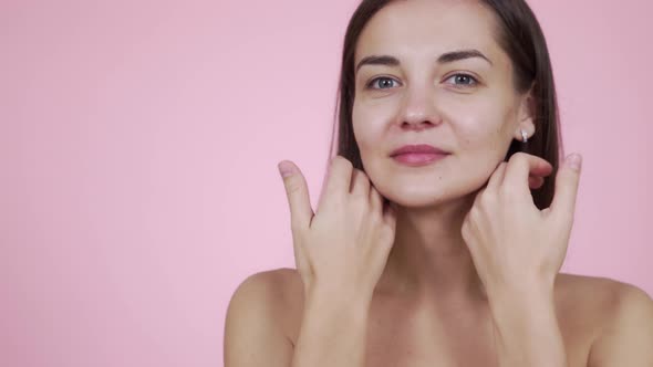 Portrait Woman with Bare Shoulders Posing on Camera Isolated on Pink Background